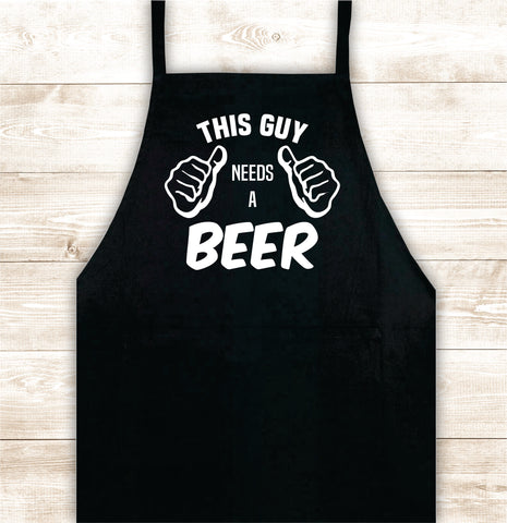 This Guy Needs A Beer Apron Kitchen Cook Grill Bake BBQ Barbeque Chef Men Women Mom Dad Family Food Gift Funny